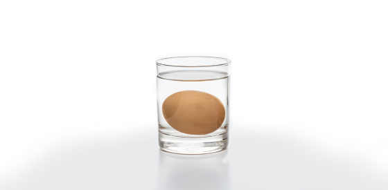 Image of an egg submerged within a glass of water