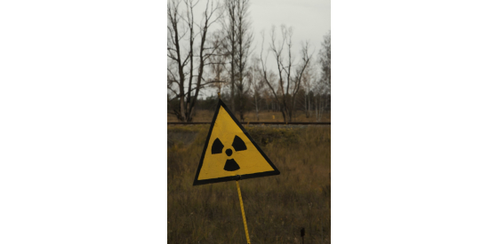 Radon is a radioactive material radiation sign on pole in the middle of a field