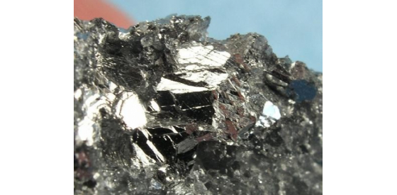 Antimony sample, grey and silver metalloid Antimony is shown as a silvery gray rock that appears to be a metal.