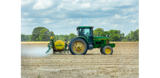 Tractor spraying herbicides Tractor spraying farm with herbicides like Alachlor that can end up in drinking water