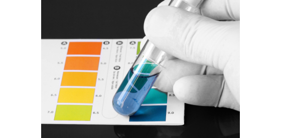 pH testing is vital in wastewater treatment Laboratory scientist doing a pH test with color strip