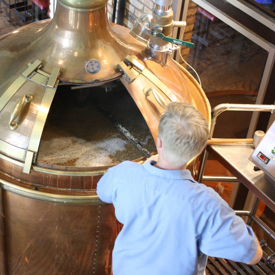 man working at brewery tank