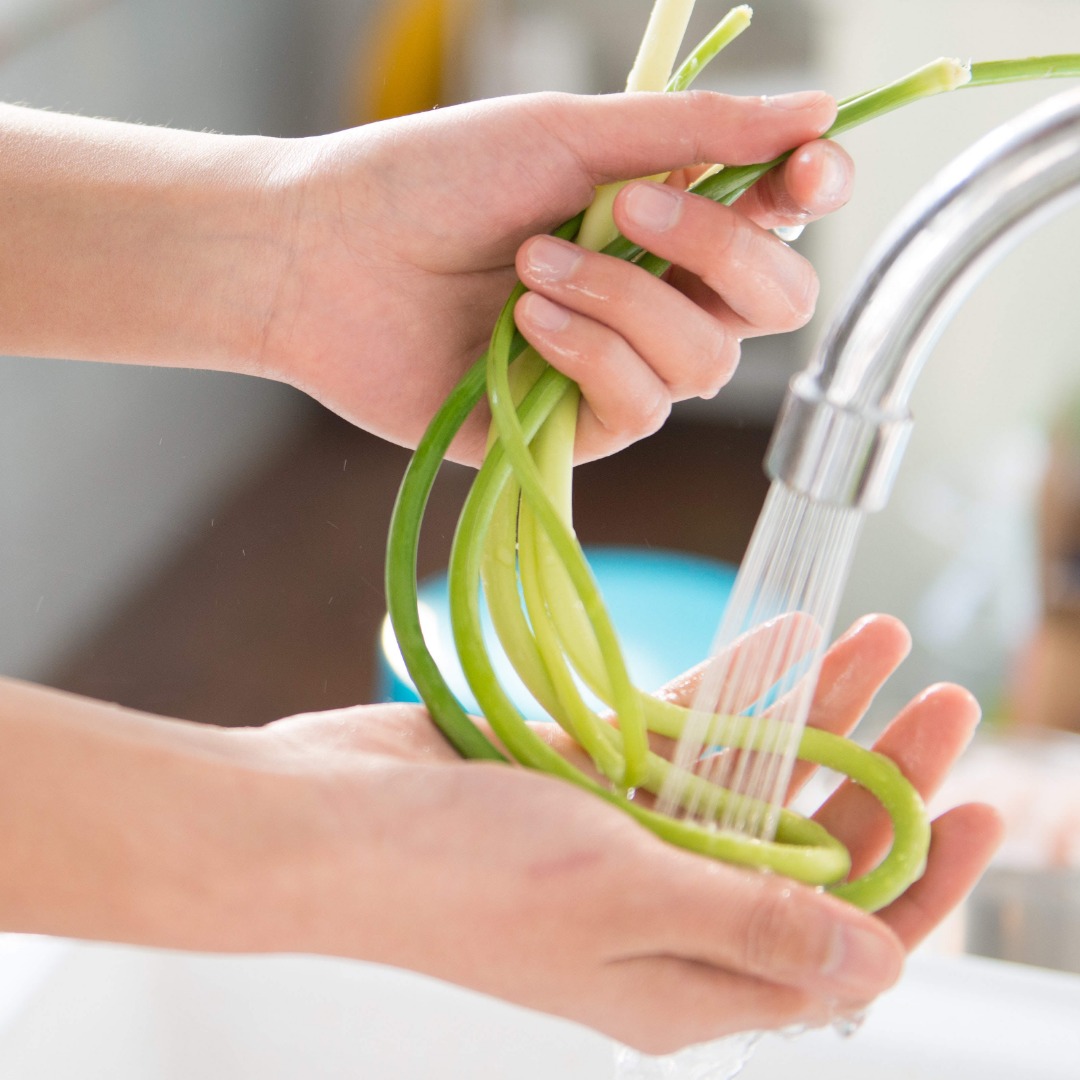 vegetables being washed in tap water
